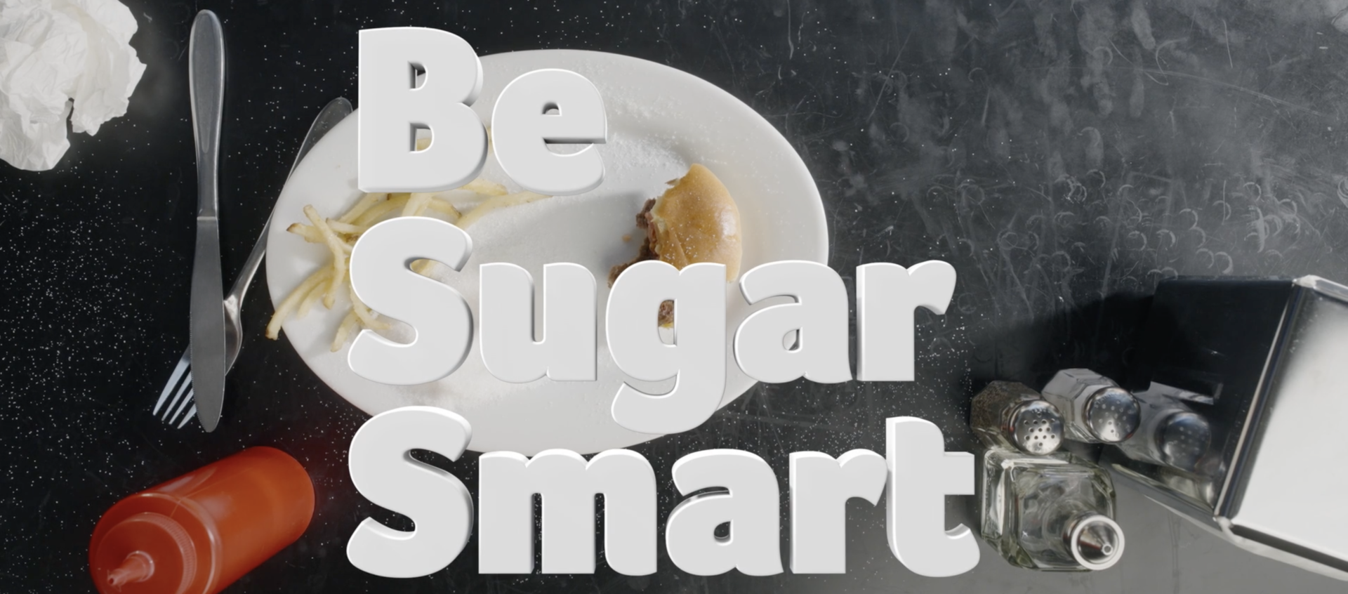 A restaurant table is showing a plate with a half eaten burger and a few leftover fries left on it. The title on the image says "Be Sugar Smart"